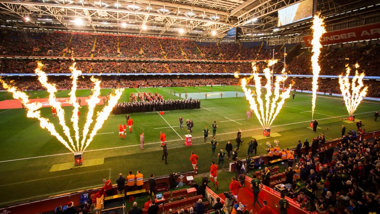 Two rugby teams walking onto a pitch for a match 